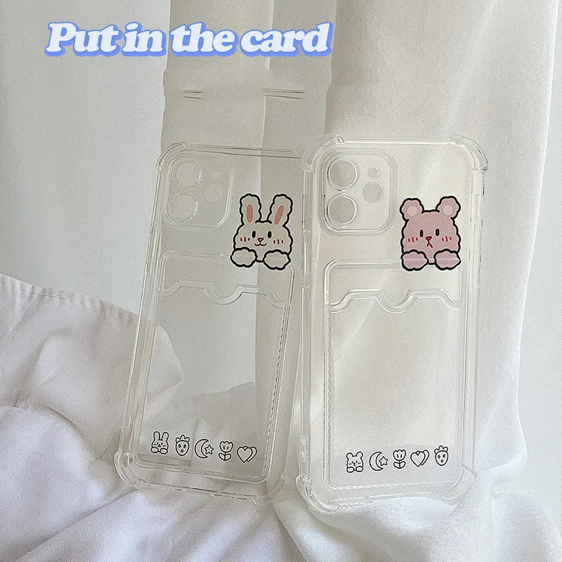 Transparent cartoon card holder phone case for Apple iPhone on a table.