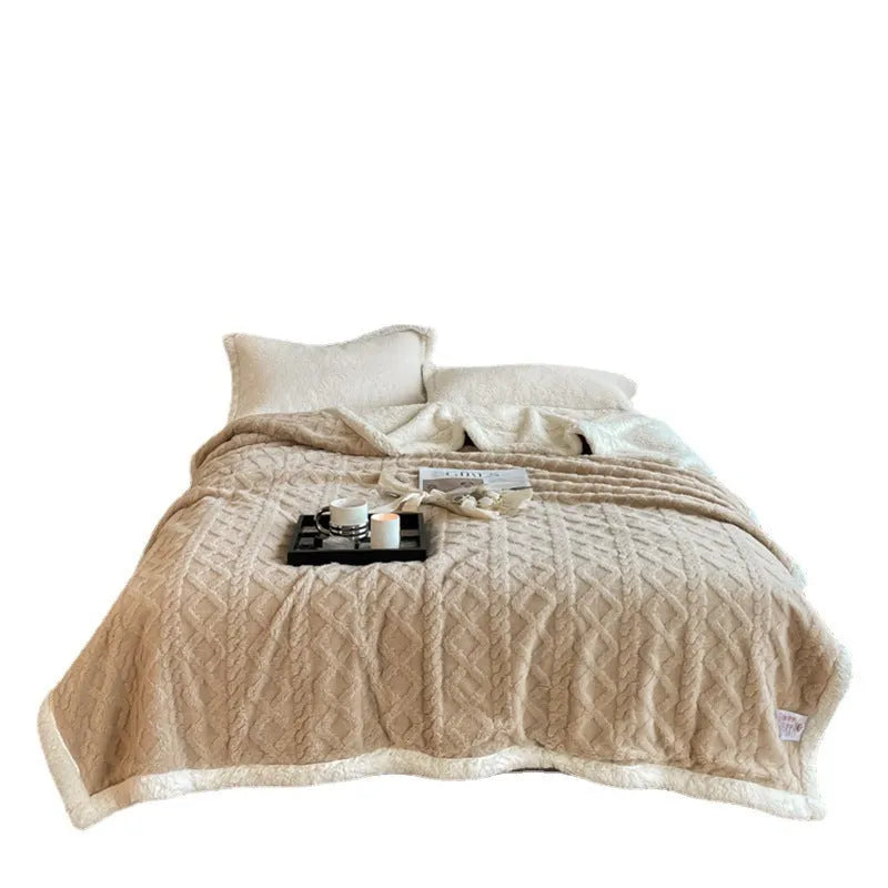 Taffeta thermal flannel winter blanket in beige draped over a modern sofa.