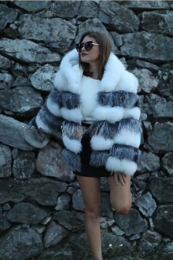 Loose-fitting women's faux fur coat with a hood in brown, shown in streetwear style.