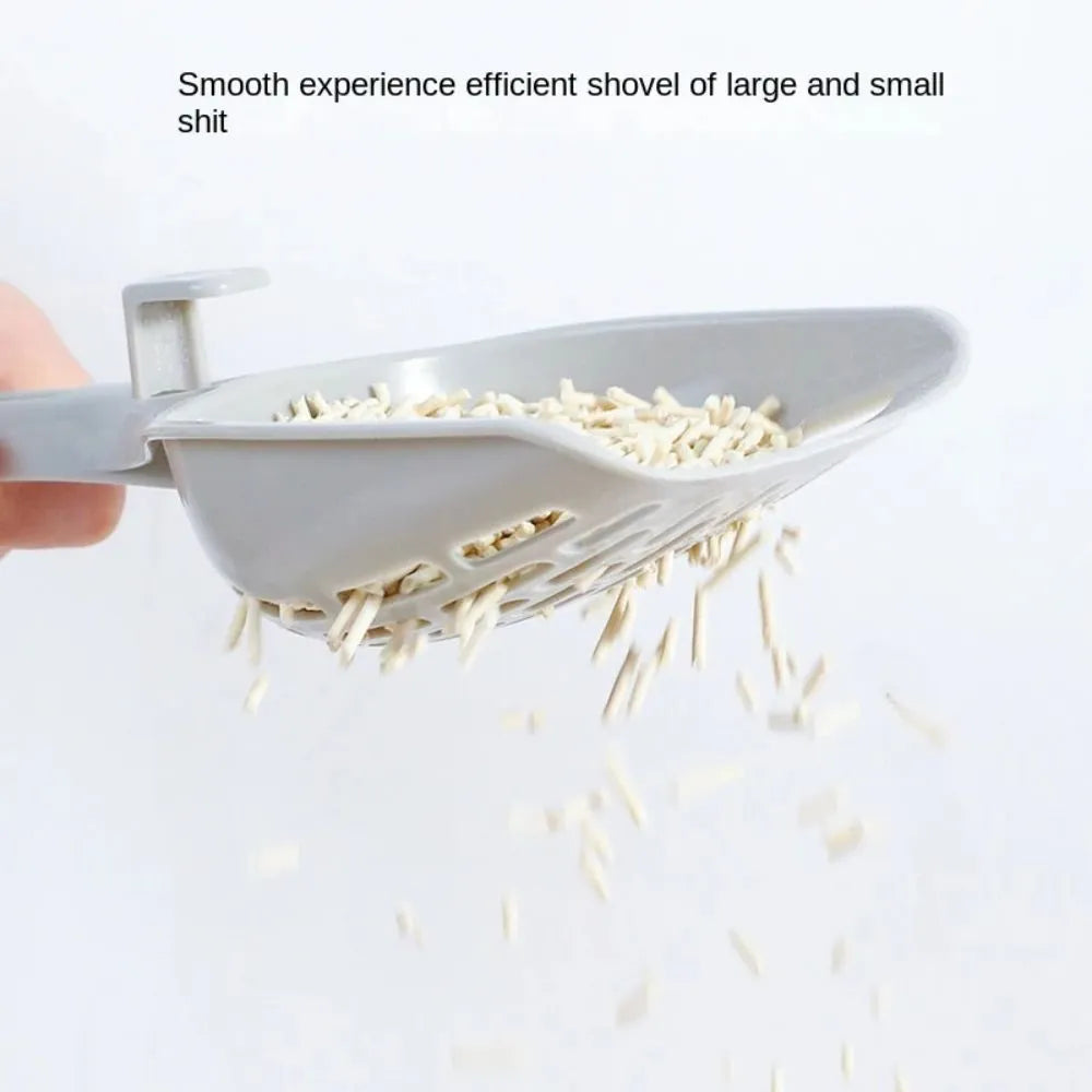 Grey plastic cat litter scoop with base stand showing drainage holes and ergonomic handle