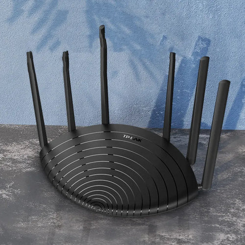 TL-WDR7661 AC1900 Gigabit Dual Band Wireless Router in black chassis on a desk.