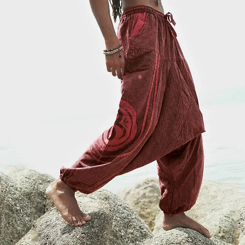 Dark green men's trousers with ethnic pattern and ankle-tied detail on polyester fabric