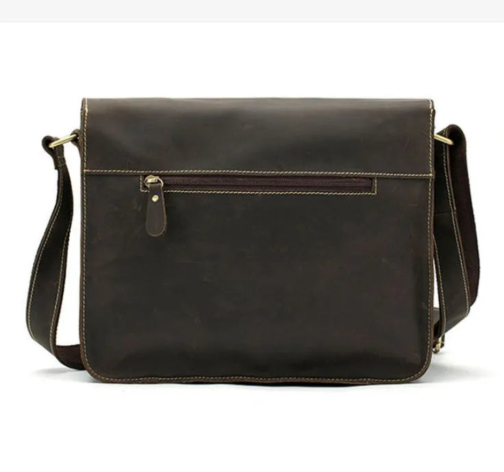 Brown leather vintage messenger bag with brass zipper and adjustable crossbody strap.