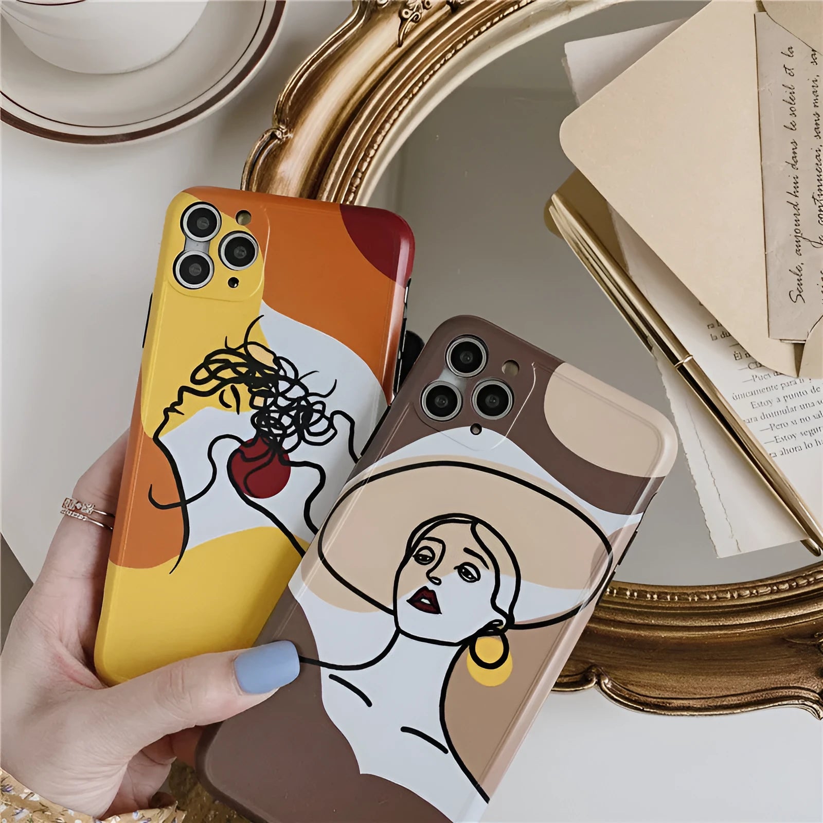 Orange yellow iPhone case with a colourful line painting cartoon design on a soft, textured surface.