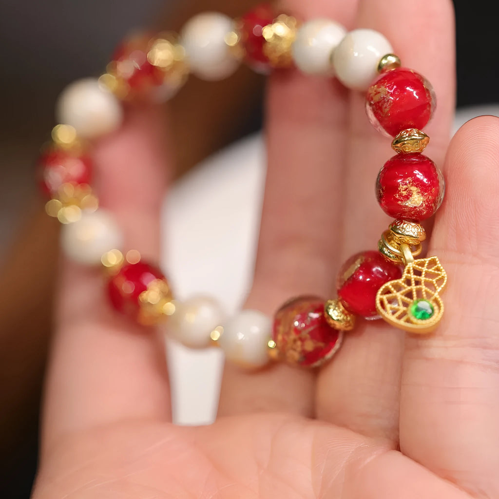 Women's ethnic bracelet with gold foil coloured glaze geometric design in pink or red colour options