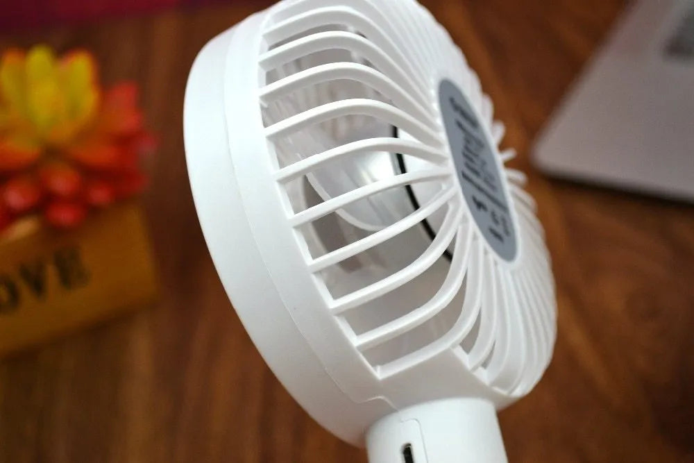White ORICO FH1 portable USB rechargeable small fan on a desktop.