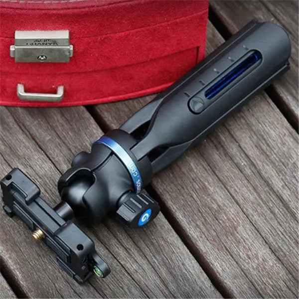 Black desktop tripod holding an iPhone, made from aluminium alloy and plastic, on a wooden table.