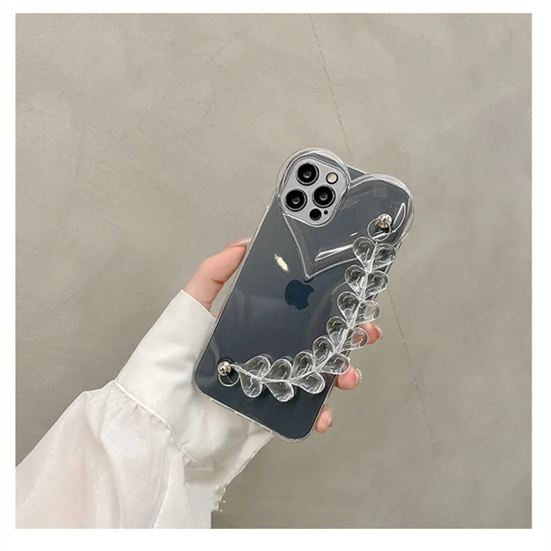 Transparent iPhone case with an attached clear love heart charm bracelet on a TPU shell.