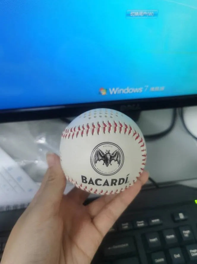 Baseball-style Bluetooth speaker in green colour showing compact design with likely control buttons.