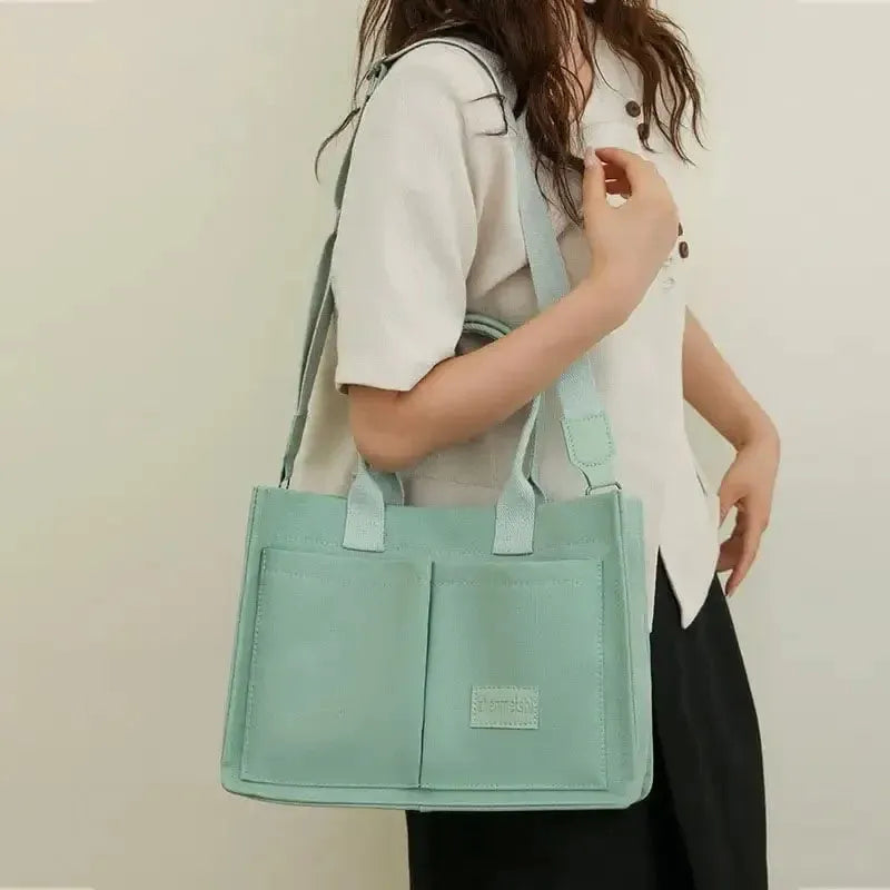 Large casual canvas tote shoulder bag for women with multiple pockets in creamy white