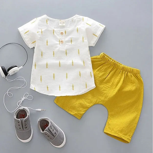 Baby boy wearing a blue cotton short sleeve t-shirt and matching shorts summer outfit