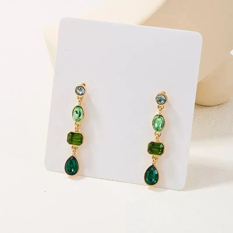 Female green round tassel long geometric earrings on display showing round acrylic and tassel drop