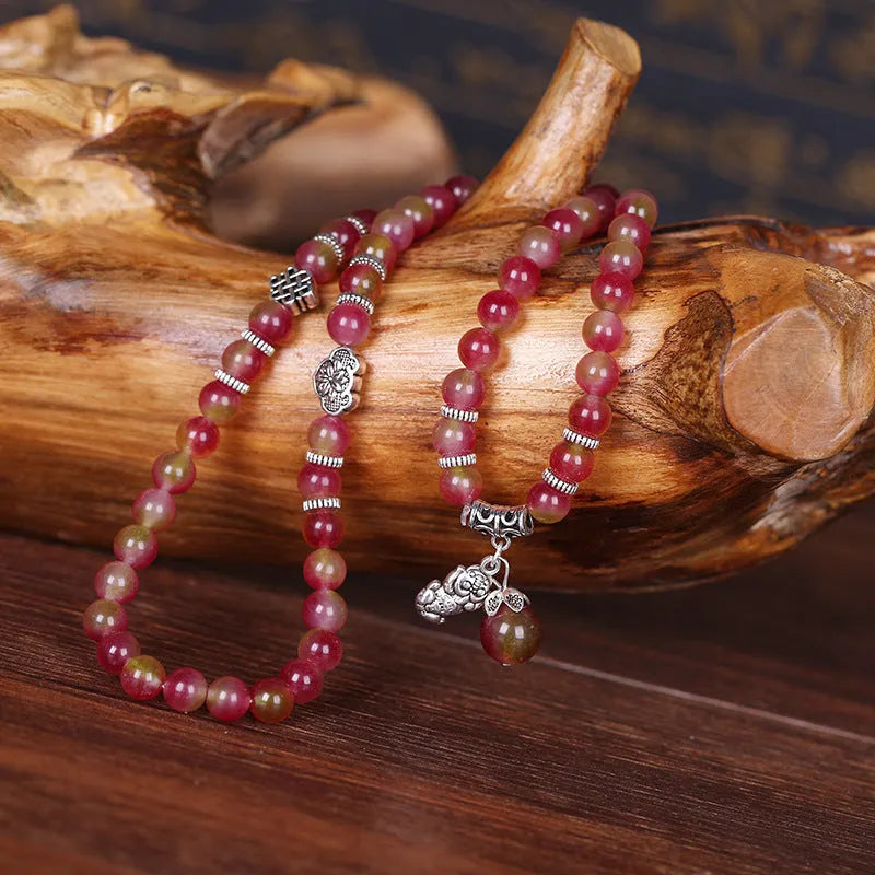 Watermelon crystal bracelet with Chinese knot design showing elephant style beads in geometric shape