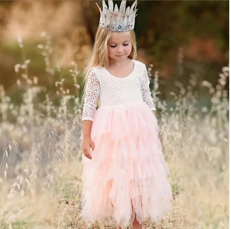 White long-sleeved lace princess dress for girls with an irregular hemline, shown on a hanger.