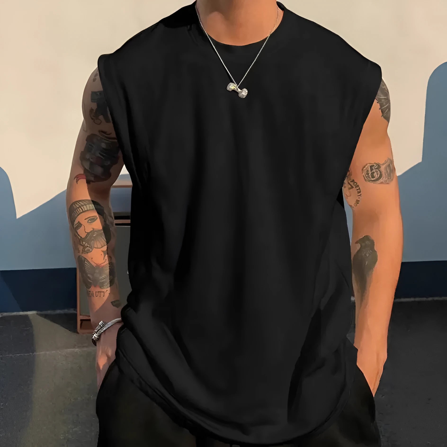 Man wearing a loose-fit solid colour cotton sleeveless tank top for summer.