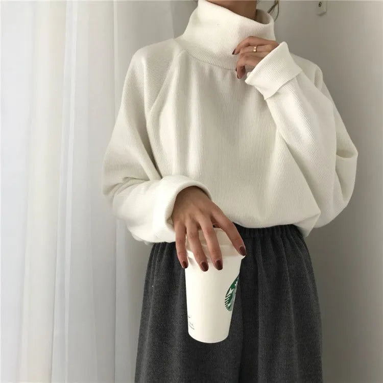 Women's solid colour long sleeve top with a half-high collar in a loose fit.