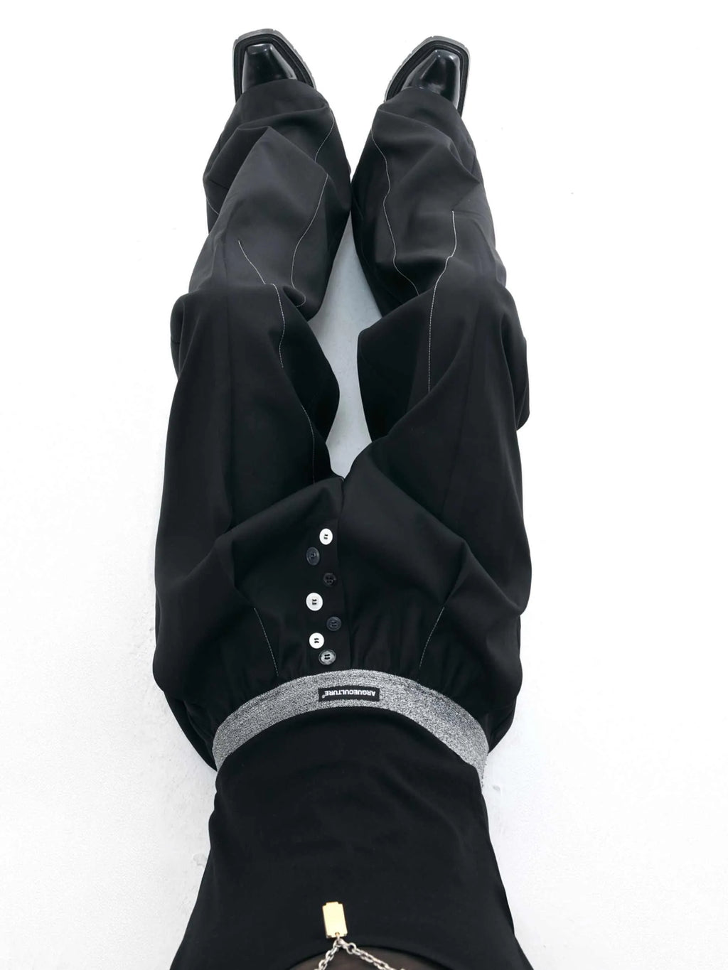 A pair of high-waisted straight-leg casual trousers in grey with a button fly front.