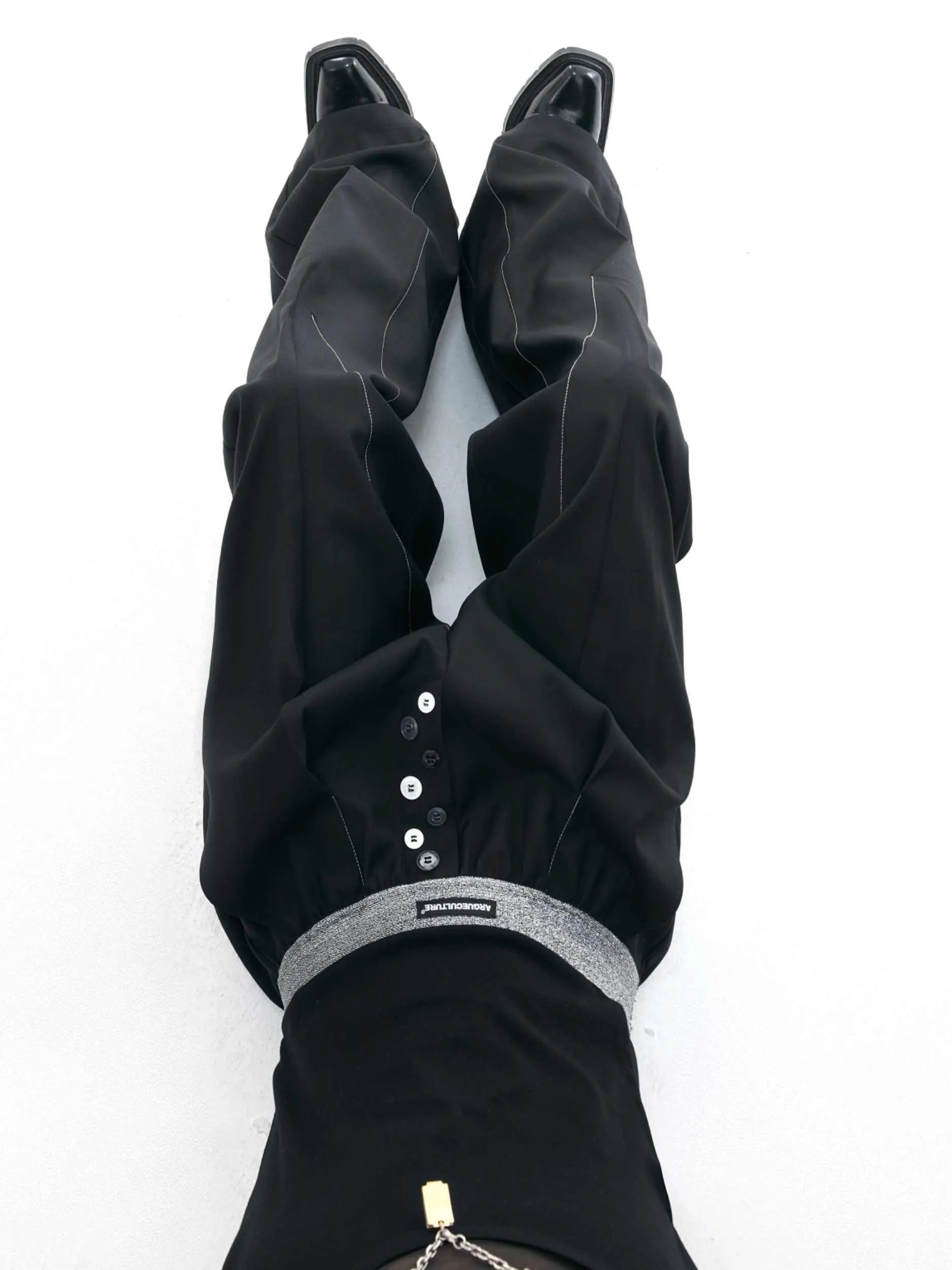A pair of high-waisted straight-leg casual trousers in grey with a button fly front.