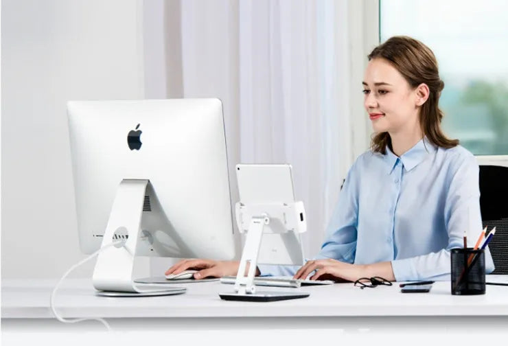 Silver foldable tablet stand showing 360-degree rotation mechanism with silicone anti-slip pads