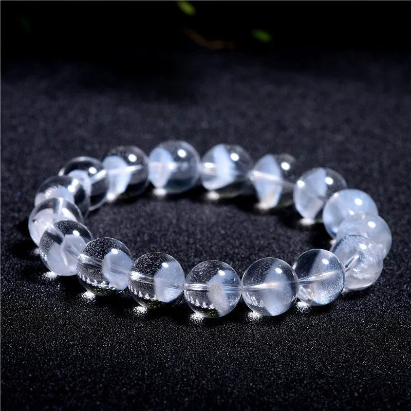Women's white crystal bracelet with a ghost pyramid centrepiece and a traditional Ruyi charm.
