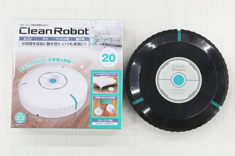 Black automatic sweeping robot cleaner on a wooden floor.