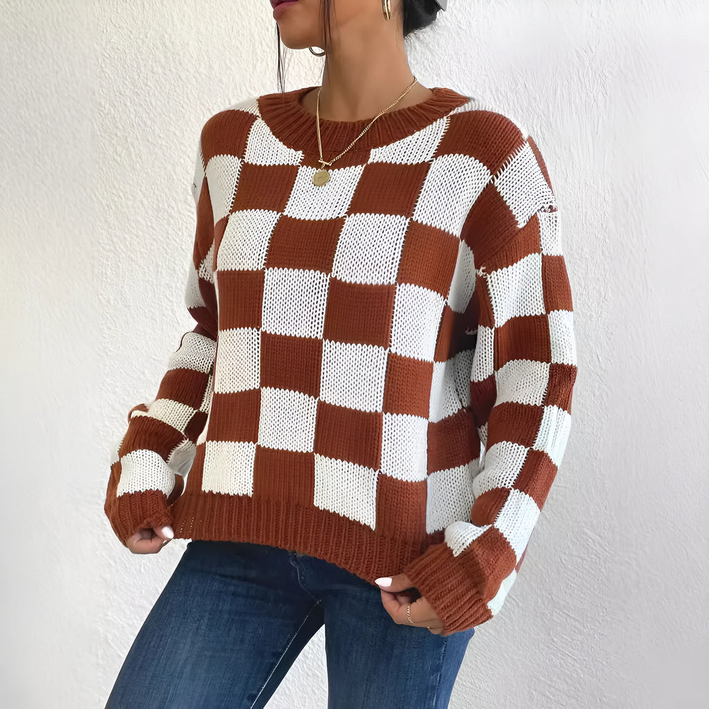 Dark brown plaid pattern on a loose round neck acrylic pullover sweater with long sleeves.