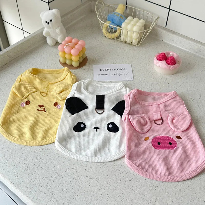 A yellow waffle-textured dog vest lying flat, showing its simple vest shape and knit pattern.
