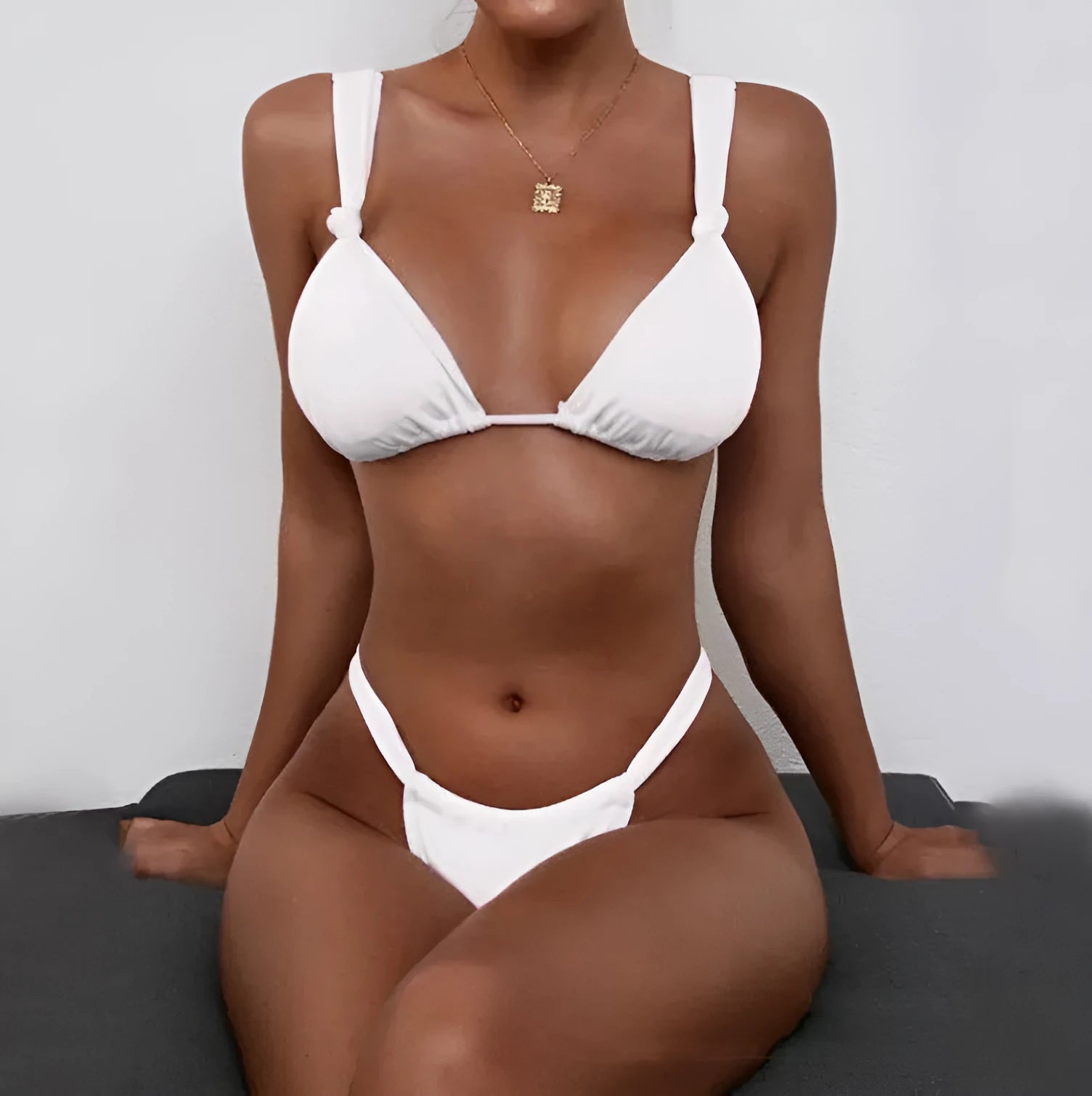 Women's pleated bikini with knotted centre and split straps in a solid colour.