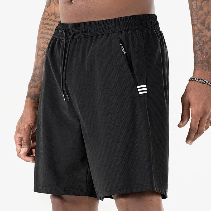 Man wearing black Ice Silk nylon sports shorts with a drawstring waist and cropped leg.