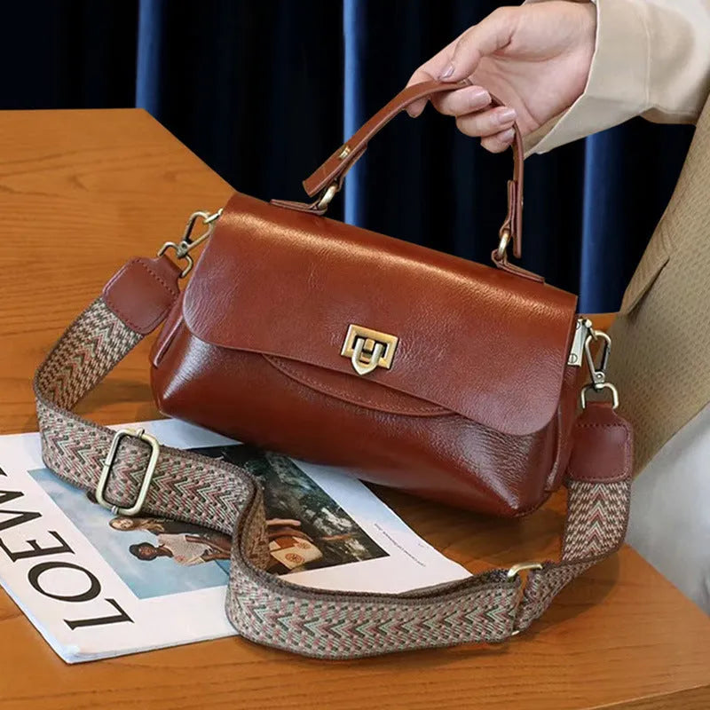 Dark brown women's saddleback leather handbag with double straps and an open front pocket.