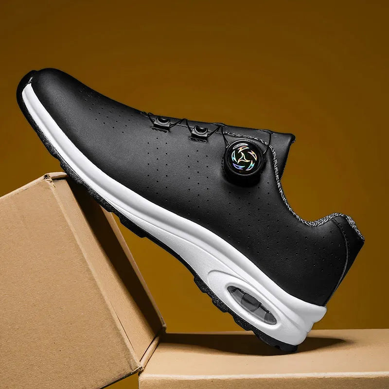 Black and white low top mesh casual shoes with lace-up front and cross shoulder straps on a composite sole.