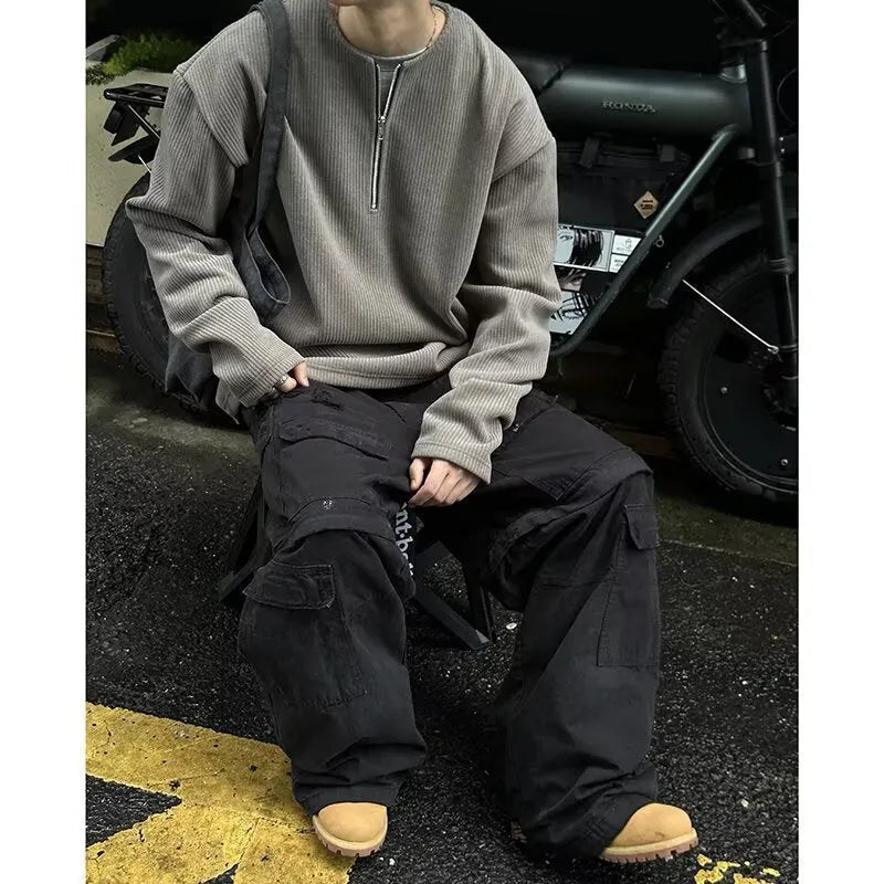 A woman's solid grey long sleeve loose fit pullover top on a hanger.
