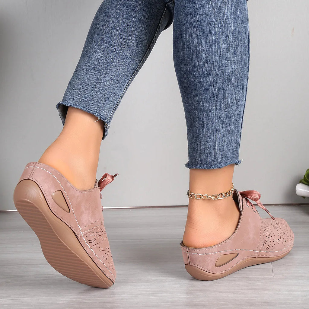 Women's black lace-up wedge slippers with hollow-out design, suede upper, and rubber sole.