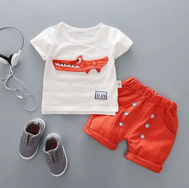 Baby boy wearing a blue cotton short sleeve t-shirt and matching shorts summer outfit