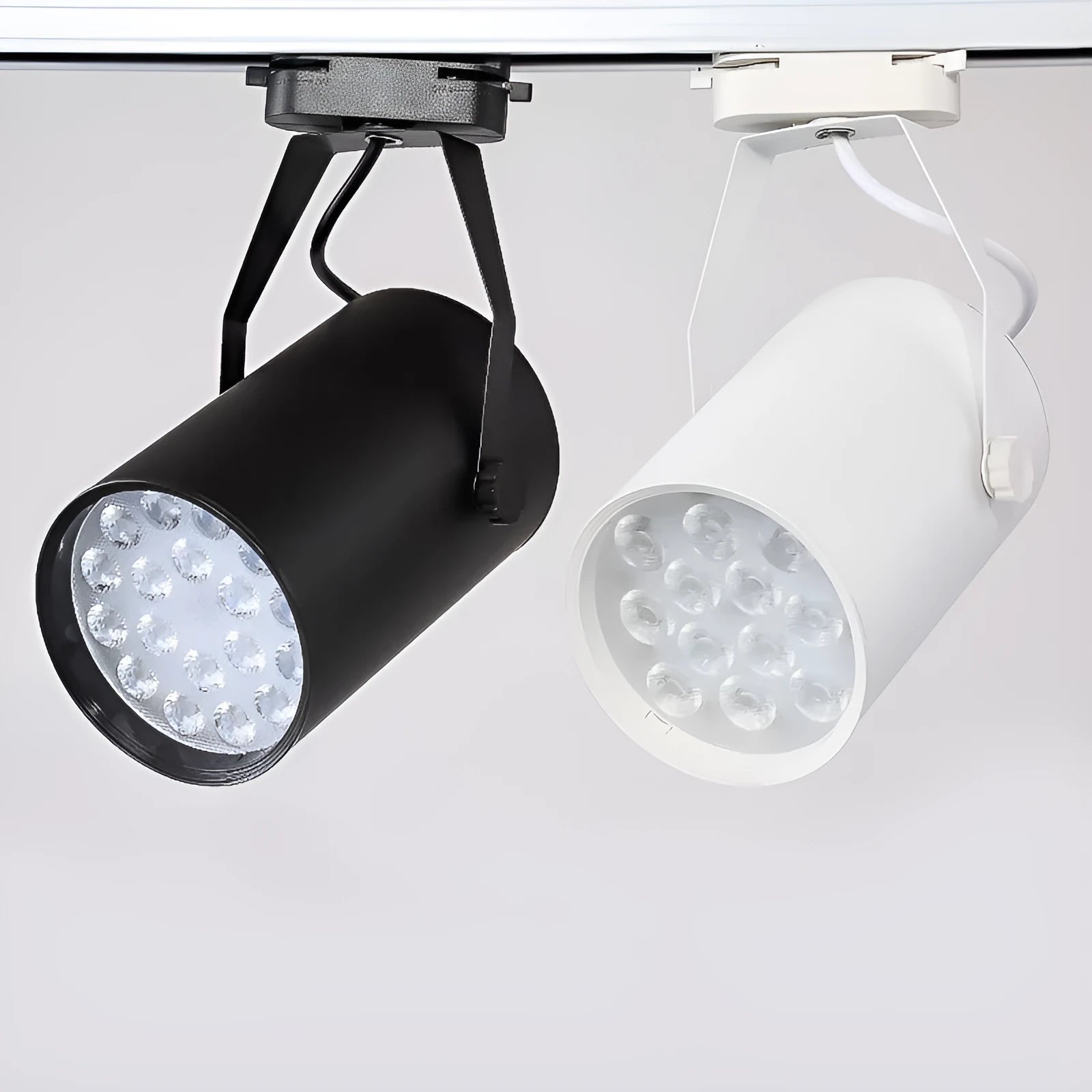 LED track spotlight with aluminium shell in black or white, available in 7W 12W 18W power outputs with warm yellow neutral white light options