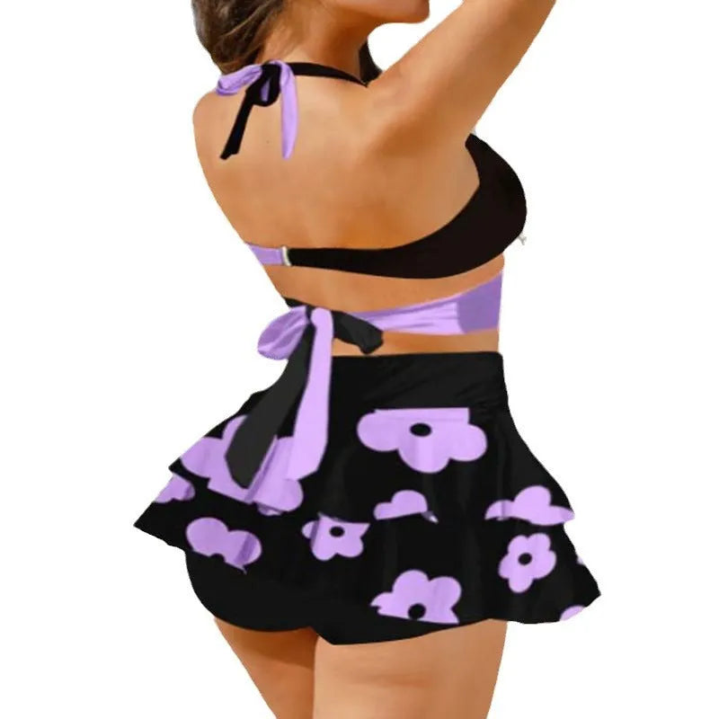Women's purple split bikini set with high-waisted briefs and matching skirt for swimming