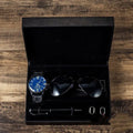 Men's gift set with brown leather watch, sunglasses, pen, and cufflinks in a gift box