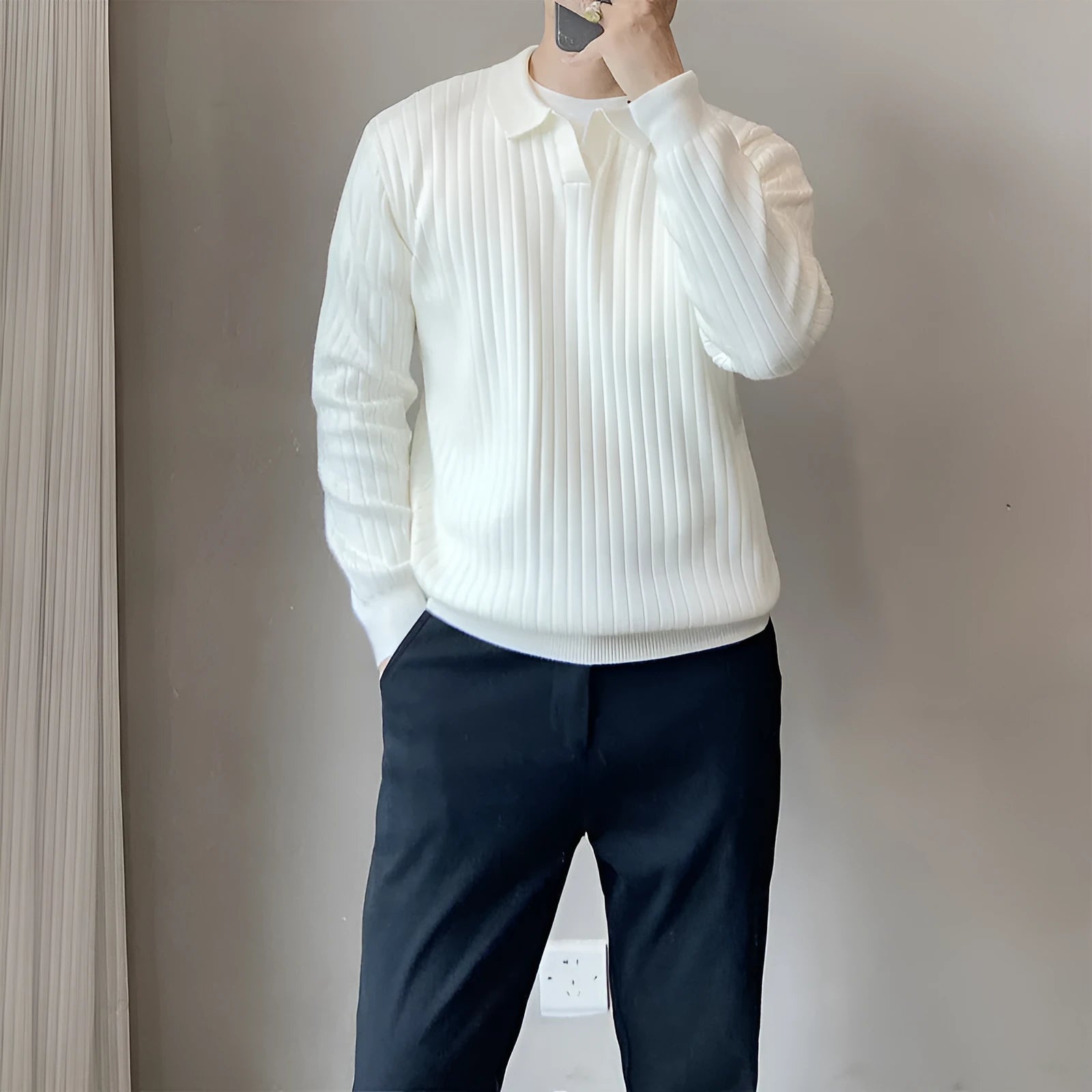 Man wearing a loose striped knitted sweater with a lapel collar in light grey.