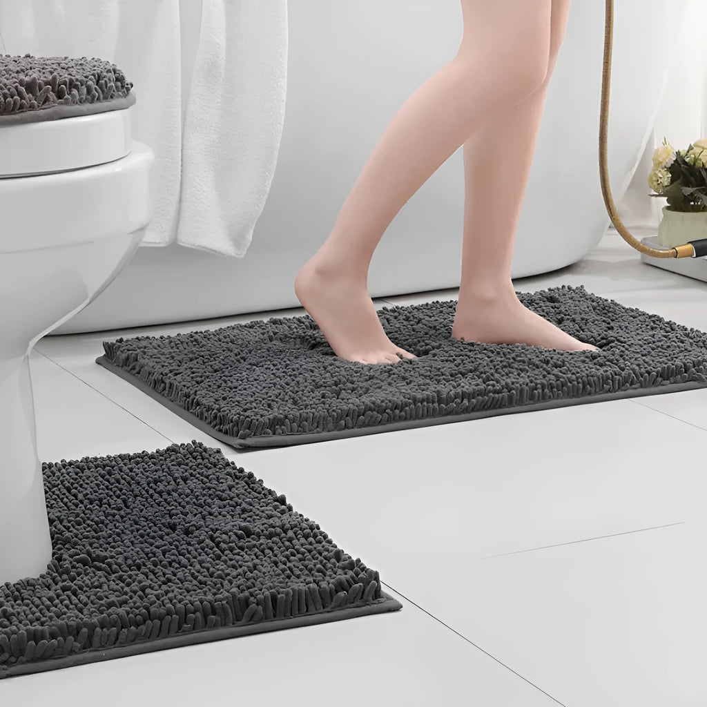 Dark green chenille U-shaped three-piece bathroom toilet carpet set on tiled floor.
