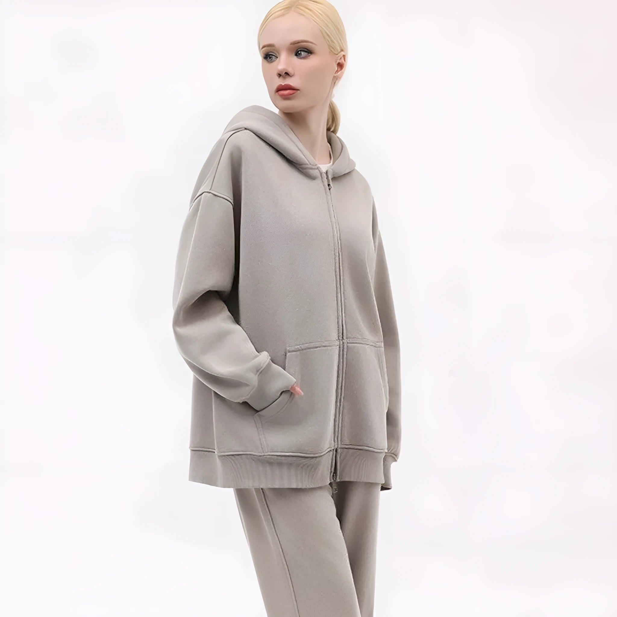 Woman wearing a fleece-lined, distressed grey hooded cardigan with patch pockets and drop shoulders.