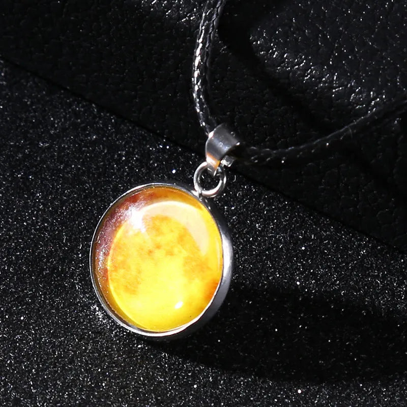 Luminous moon and constellation glass pendant on a silver alloy necklace chain with an extension piece.