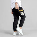 Boys' cotton track pants in black size 120cm on a child model