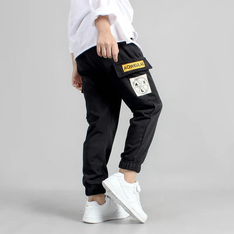 Boys' cotton track pants in black size 120cm on a child model