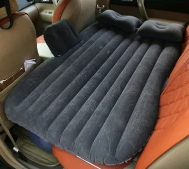 Universal inflatable car bed with flocked cloth, shown with two pillows and a pump.