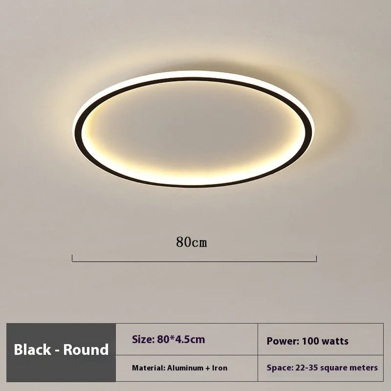 Modern circular minimalist LED ceiling lamp in black finish, shown mounted on a white ceiling.