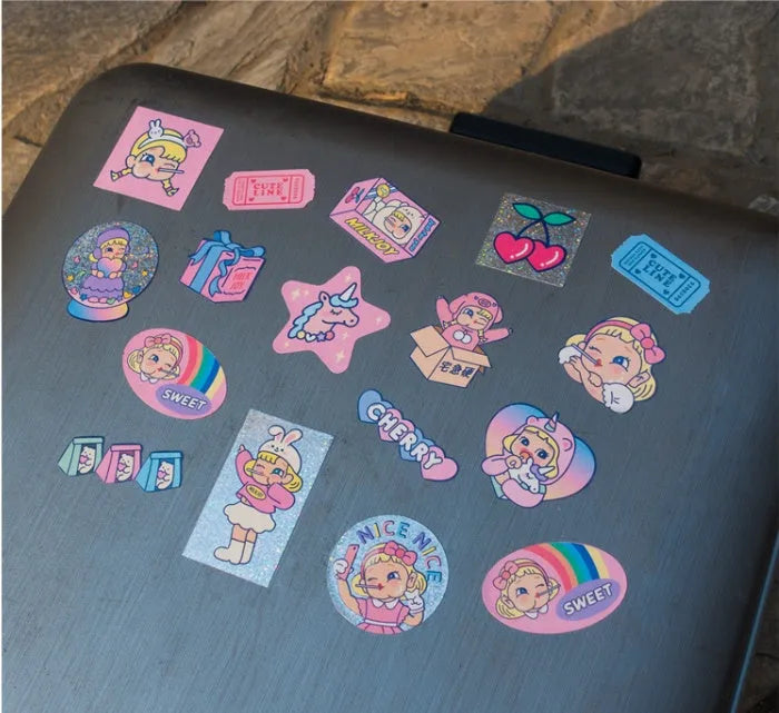Cartoon sticker set showing 16 square PVC decals and storage box with cute girl and comic designs.