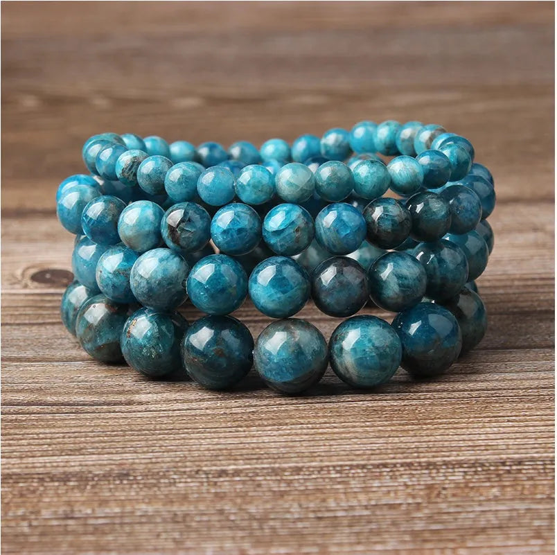 Natural blue apatite elastic beaded bracelet with polished round beads, unisex design, shown on a neutral background
