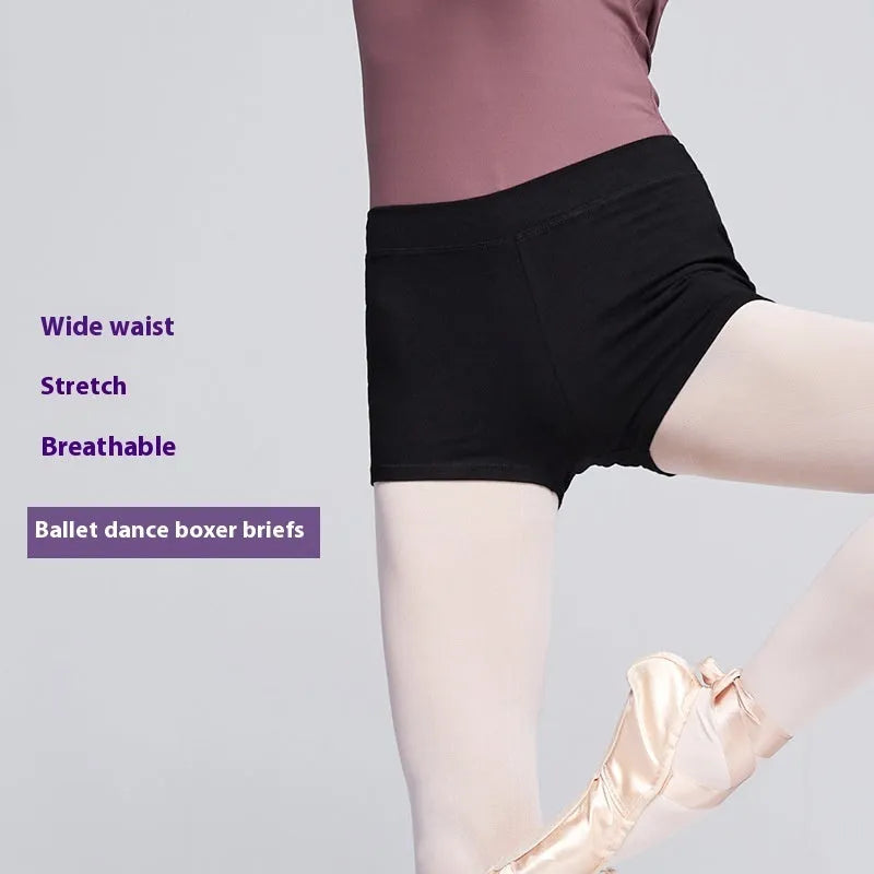 Black women's cotton dance practice shorts laid flat, showing solid colour and simple design.