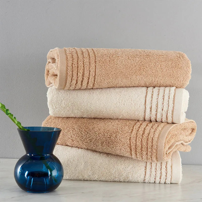 Cotton towel set in beige and brown showing three different sizes including large bath towel