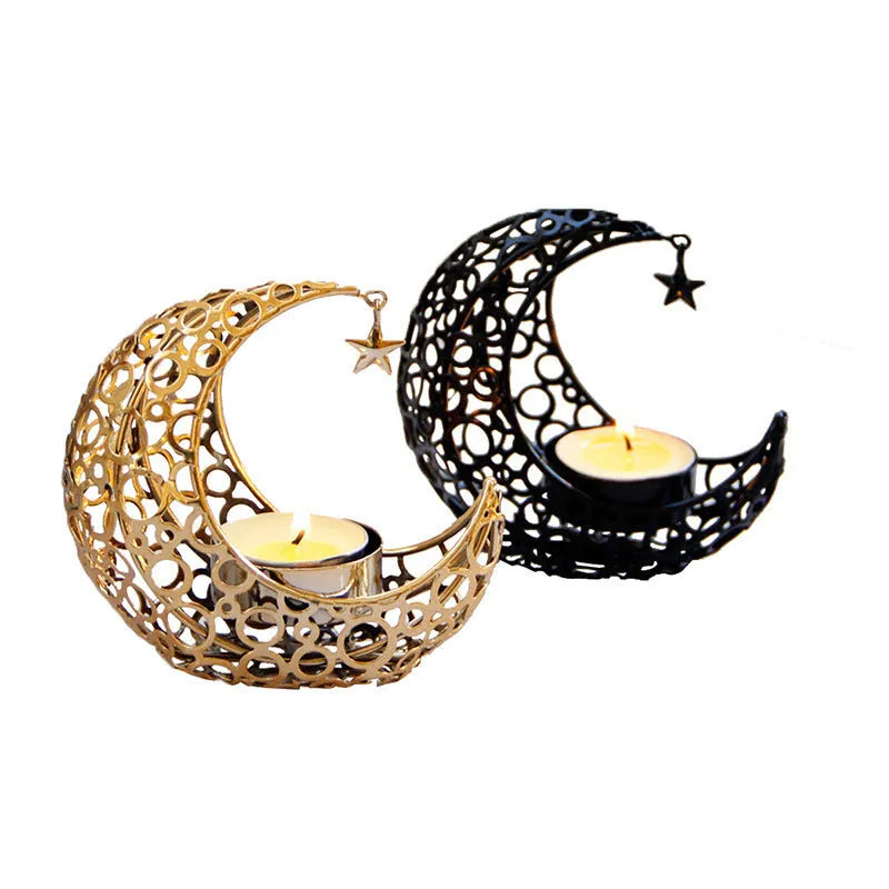 Gold metal crescent moon candle holder with hollow design on a dark surface